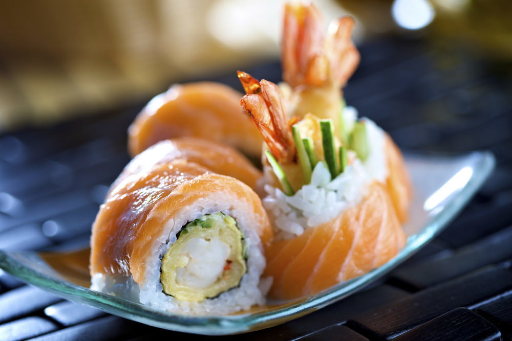 Big futomaki sushi with salmon, prawn tempura and cucumber